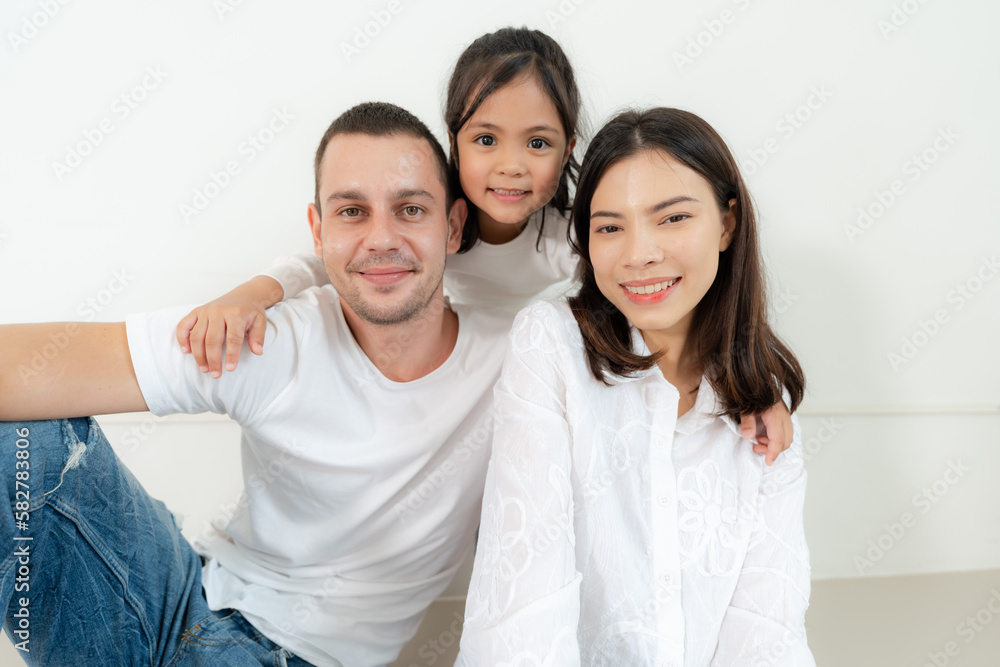 Happy family portrait with parents and little daughter. Happy family portrait with parents and little daughter.