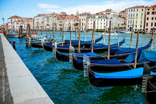 Row of blue covered gondolas moored onto the pier in Venice  Italy