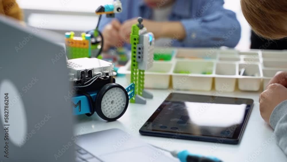 Robotics programming class. Children construct and code Robot. STEM education using constructor blocks and laptop tablet, remote control joystick. Technology educational development for school kids Robotics programming class. Children construct and code Robot. STEM education using constructor blocks and laptop tablet, remote control joystick. Technology educational development for school kids