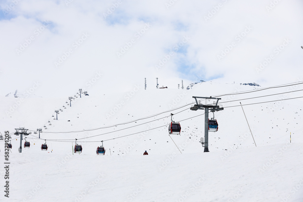 cable car are move on snowy mountain with skiers top view cable car are move on snowy mountain with skiers top view