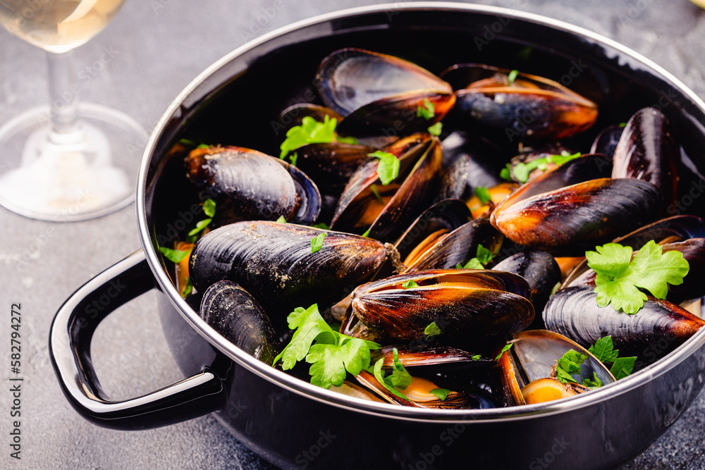 Delicious seafood mussels with sauce and parsley. Delicious seafood mussels with sauce and parsley.