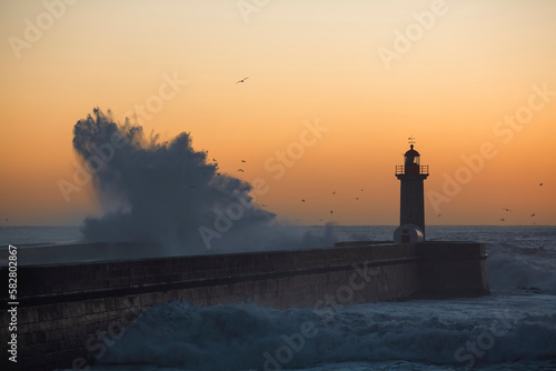 Big waves at the lighthouse in Porto, Portugal.