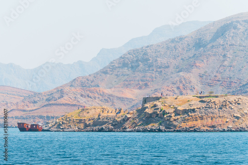 Tour boats and tourist on Mirellas island in Musandam. Oman. Middle east. Famous travel destination in Oman Khassab peninsula