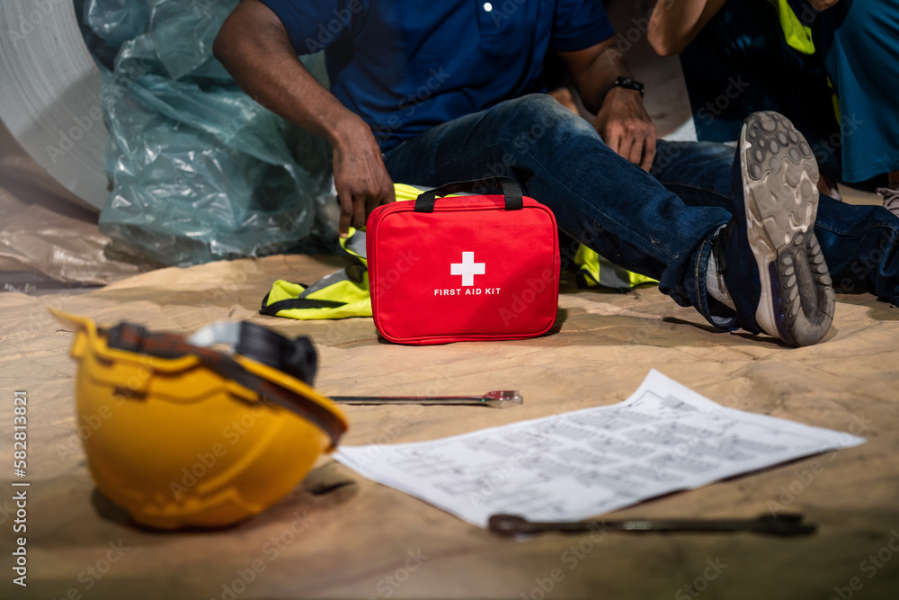 Emergency staff in safety suit use first aid kit to help a man who has