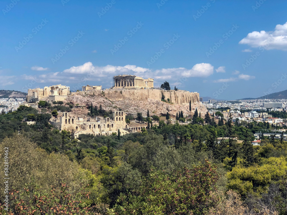 Naklejka premium The Acropolis of Athens, Greece, with the Parthenon Temple on top of the hill during a summer sunset