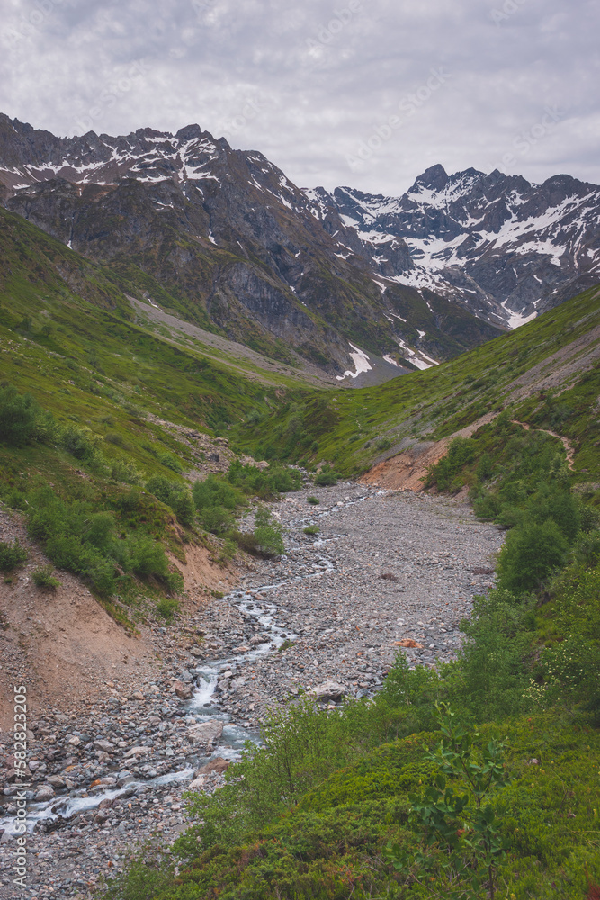 A picturesque landscape of a river flowing through the Alps mountains in the Valgaudemar valley (Les Oulles du Diable)
