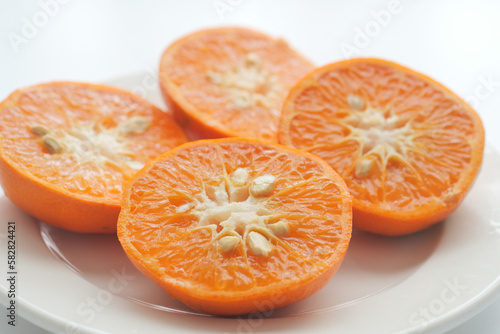 close up of slice of orange fruits in a bowl 