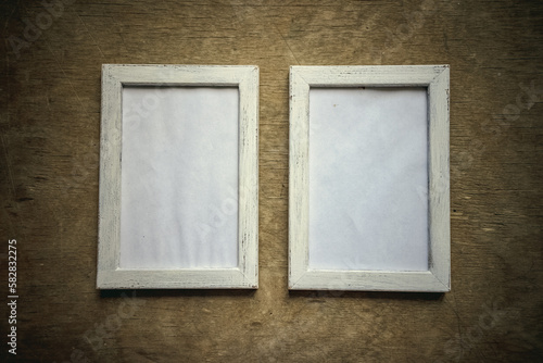 Two vintage vertical photo frames made of wood in vintage style.Making two framed photos on a wooden wall.