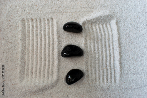 black stone in sand 