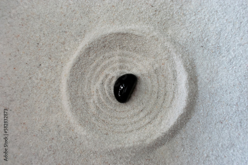black stone in sand circle
