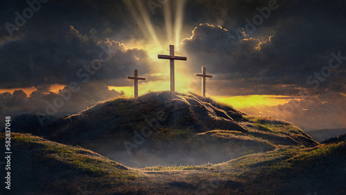 3 Crosses on a hill with sun rays and clouds in the background