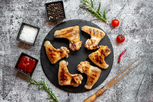 grilled chicken wings on stone background 