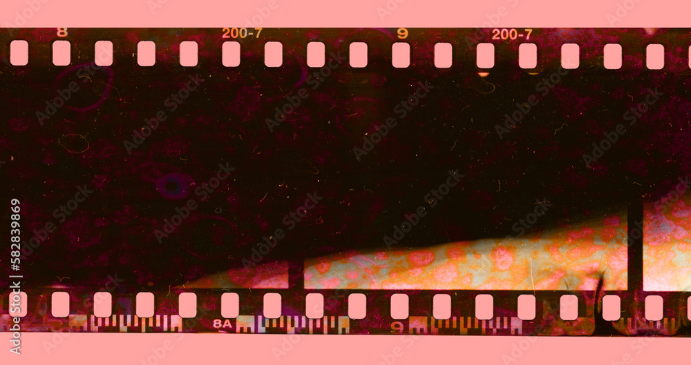 single 35mm filmstrip with strange developing chemical smear marks, film texture, surface.