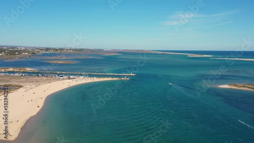 Aerial view. Drone flight over natural Portuguese park Ria formosa over the village of Fuseta. Clear turquoise water with sand dunes