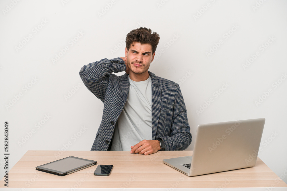 Young entrepreneur man working with a laptop isolated touching back of head, thinking and making a choice. Young entrepreneur man working with a laptop isolated touching back of head, thinking and making a choice.
