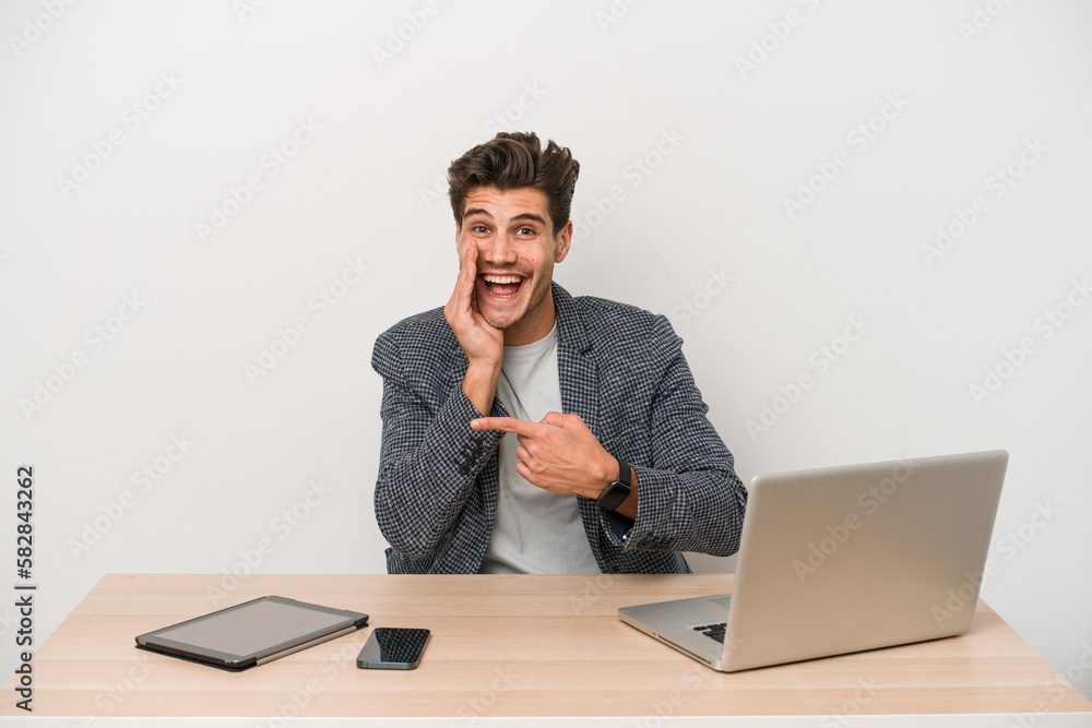 Young entrepreneur man working with a laptop isolated saying a gossip, pointing to side reporting something. Young entrepreneur man working with a laptop isolated saying a gossip, pointing to side reporting something.