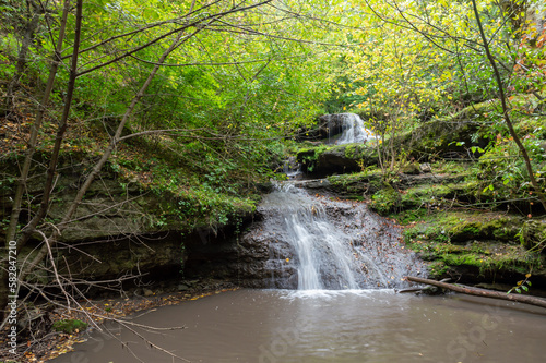 A small waterfall flows into the river