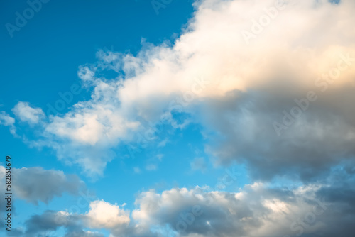 Blue sky with white cumulus clouds moving fast in day light. Cloudscape. Nature background. Windy weather forecast. Religion concept. Heaven landscape. Fresh air. Morning inspiration. Daylight