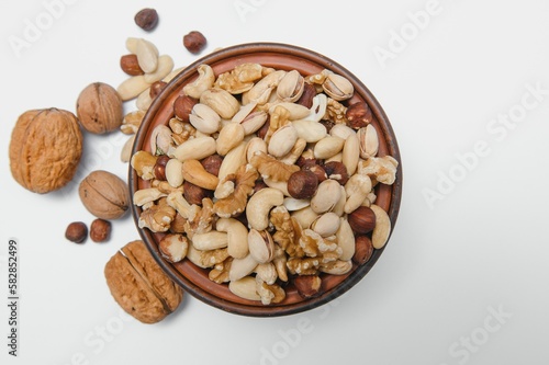 Mixed nuts on a plate. White background