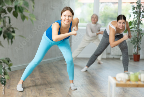 Sporty women learning aerobic dances in wellness center