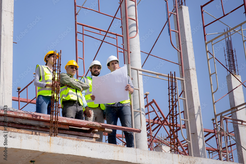 Team group of contractor and architect with foreman explaining about scheme building site for planning project to worker and looking blueprint, construction site, development and structure.