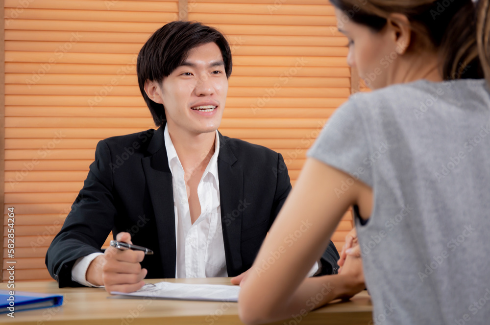 Young woman talking and negotiating about agreement and contract of document with consultant or agent at home office, businessman explaining with client about insurance, two people, business concept. Young woman talking and negotiating about agreement and contract of document with consultant or agent at home office, businessman explaining with client about insurance, two people, business concept.