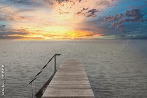 Tramonto sul lago di garda con pontile e scaletta