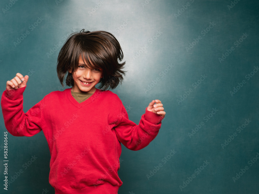 Boy in a red sweater dancing to the rhythm of the music Boy in a red sweater dancing to the rhythm of the music
