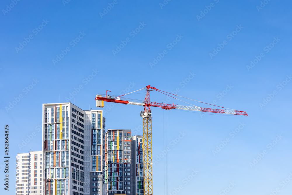 Tower cranes on the construction site of a block of flats of the monolithic residential apartment building Tower cranes on the construction site of a block of flats of the monolithic residential apartment building