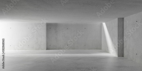 Abstract large, empty, modern concrete room with ceiling opening and light from the left and rough floor - industrial interior background template