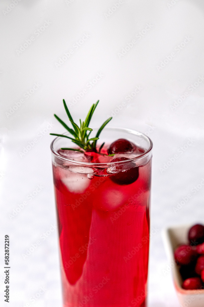 Cranberry juice in a glass on a table with a white tablecloth Cranberry juice in a glass on a table with a white tablecloth