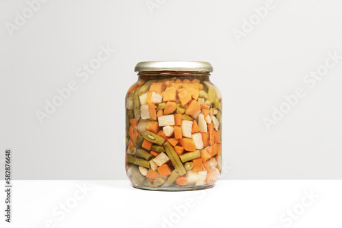 A large glass jar with a canned vegetable stew