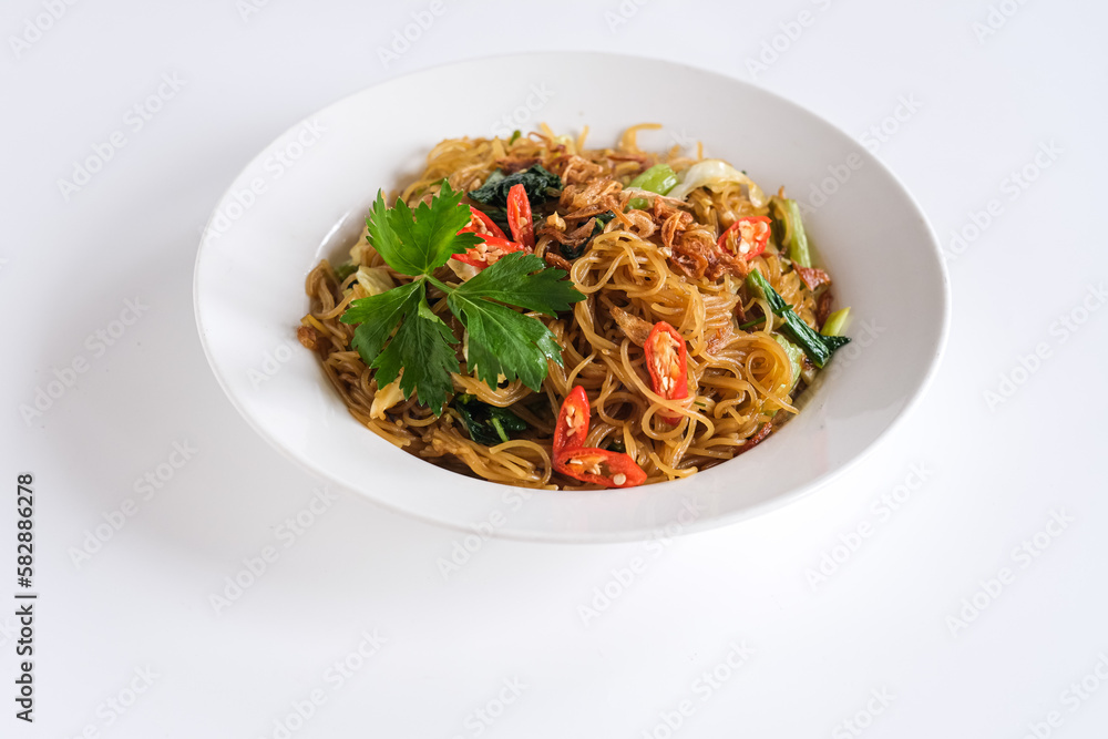 bihun goreng or stir fried rice vermicelli with vegetables and chili. a food with delicious, spicy and sweet taste bihun goreng or stir fried rice vermicelli with vegetables and chili. a food with delicious, spicy and sweet taste
