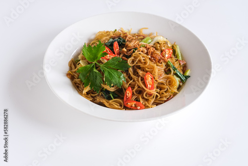 bihun goreng or stir fried rice vermicelli with vegetables and chili. a food with delicious, spicy and sweet taste 