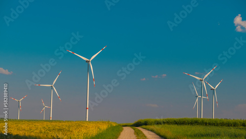  renewable energy.Ripe wheat and windmills.Wind energy.Wind generators in a wheat field.Electricity and green energy concept.Green Energy Source