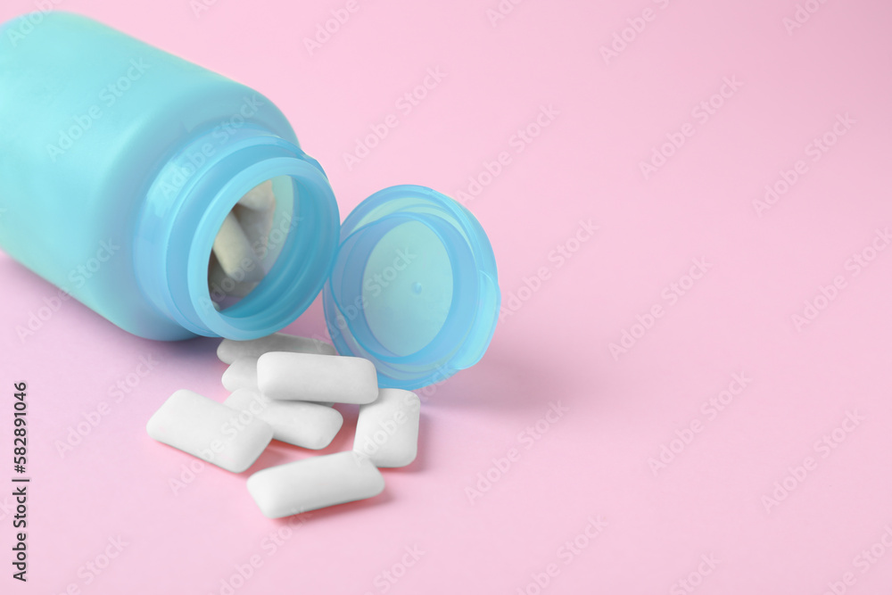 Jar with chewing gums on pink background, closeup. Space for text Jar with chewing gums on pink background, closeup. Space for text
