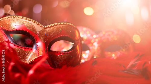 Venetian masks on red glitter shiny streamers on abstract defocused bokeh lights