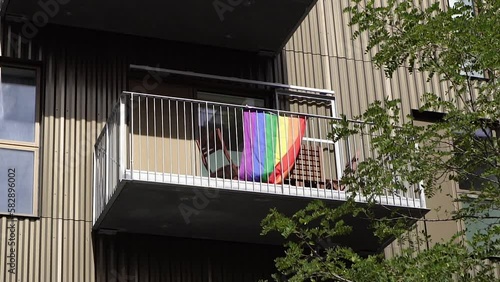 Rainbow flag. A flag of all colors of the rainbow hangs on the balcony.