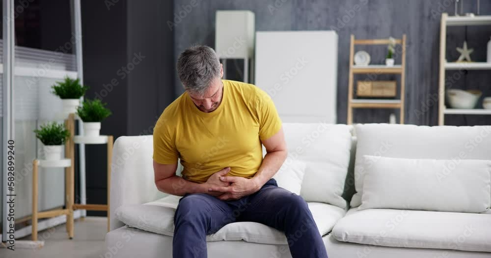 Man Suffering From Stomach Ache Sitting Man Suffering From Stomach Ache Sitting