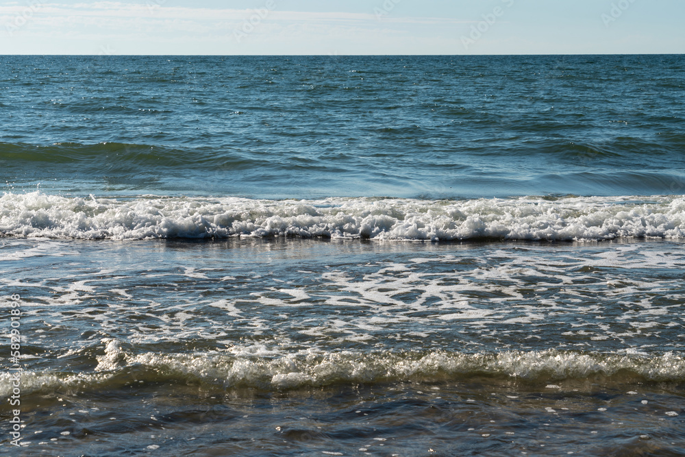 View of the incoming wave on the Baltic Sea on the shore of the Curonian Spit on a summer day, Kaliningrad region, Russia View of the incoming wave on the Baltic Sea on the shore of the Curonian Spit on a summer day, Kaliningrad region, Russia