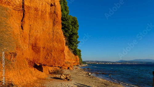 A Stunning View of Metamorphosis' Red Cliffs and Blue Ocean photo