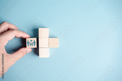 Health and Life insurance of protect family concept. hands holding plus and healthcare medical icon on wooden cube block, health and access to welfare health concept...