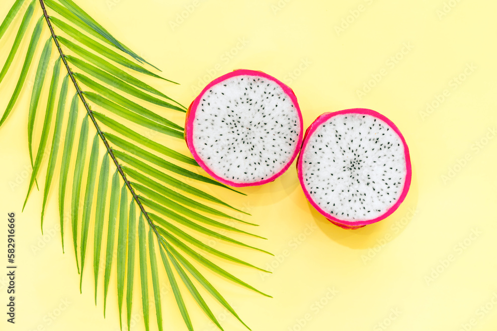 Dragon fruit, Pitaya or Pitahaya with leaf on yellow background. Top view. Flat lay Dragon fruit, Pitaya or Pitahaya with leaf on yellow background. Top view. Flat lay