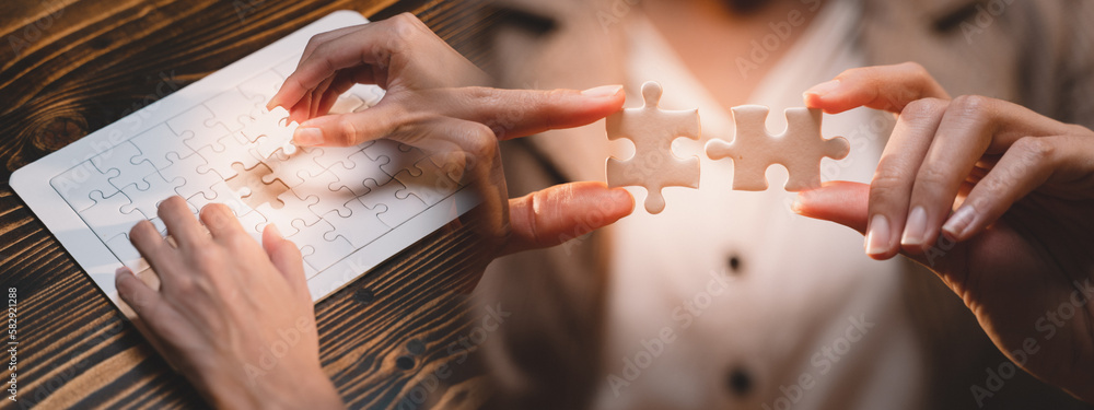 Banner background of business hands connecting jigsaw puzzle, success and goal achievement, the last jigsaw is the link of all the pieces. strategic planning or a solution for the management. Banner background of business hands connecting jigsaw puzzle, success and goal achievement, the last jigsaw is the link of all the pieces. strategic planning or a solution for the management.