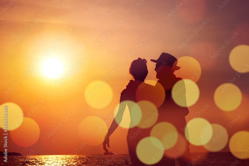 Silhouette Happy Mature couple  happy retirement planning concept, Beautiful and happy senior couple in love and enjoying retirement celebrating walking on the beach with flare and bokeh light.