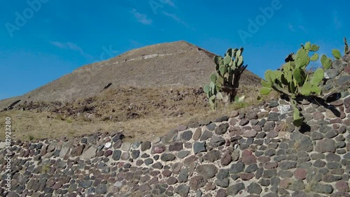 Stunning beauty of  a Teotihuacan's Pyramid, with the magnificent blue sky above,  the Pyramid stands tall amidst lush green surroundings photo