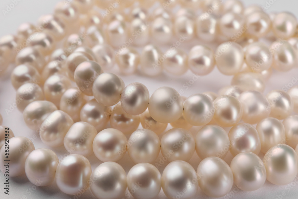 Elegant pearl necklace on white background, closeup Elegant pearl necklace on white background, closeup