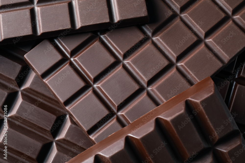 Many delicious dark chocolate bars as background, top view Many delicious dark chocolate bars as background, top view