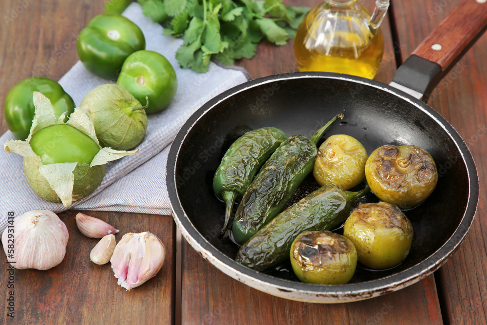 Different ingredients for cooking tasty salsa sauce on wooden table Different ingredients for cooking tasty salsa sauce on wooden table