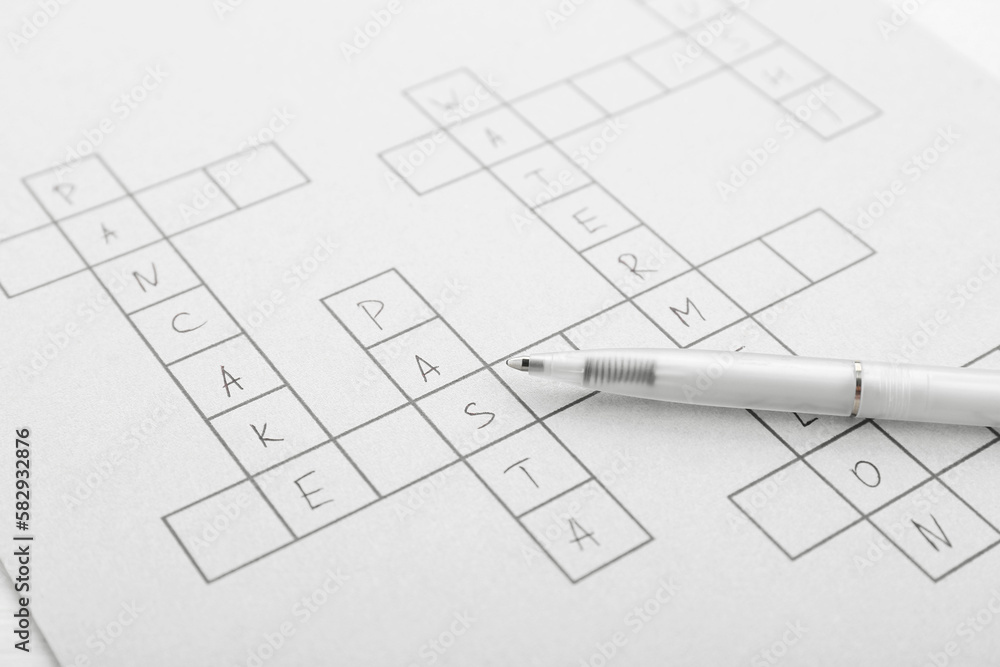 Crossword with answers and pen, closeup view Crossword with answers and pen, closeup view